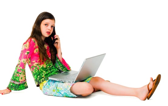 Caucasian girl using a laptop and a mobile isolated over white