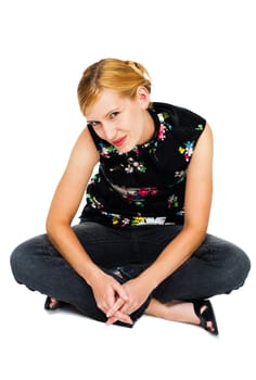 Beautiful young woman sitting and smiling isolated over white