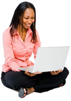 Close-up of a woman using a laptop and smiling isolated over white