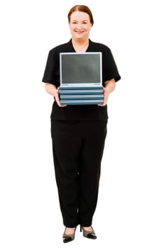 Confident woman holding a stack of laptops isolated over white