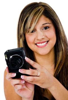 Young woman photographing with a camera and smiling isolated over white