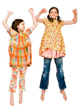 Happy girls jumping together isolated over white
