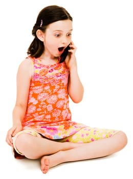 Surprised girl talking on a mobile phone isolated over white