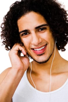 Handsome man listening to music with earbuds isolated over white