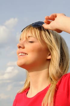 Laughing young woman in sunglasses