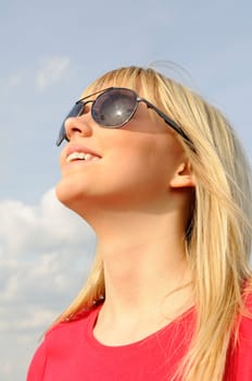 Laughing young woman in sunglasses