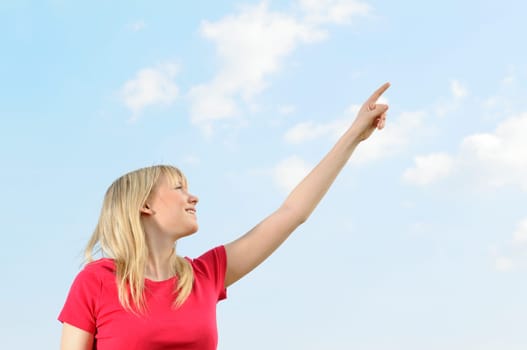 Young woman pointing at the sky