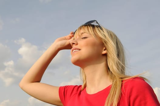 Laughing young woman in sunglasses