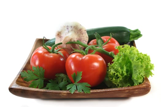 a wooden plate with various vegetables