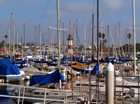 A lighthouse watches over the many sailboats moored in Oceanside Harbor in Oceanside, California