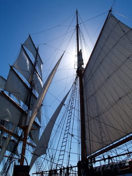 Sun shining behind the mast of the Star of India that is moored at the “Maritime Museum” in San Diego, California.