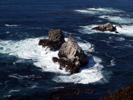 Waves crashing among the rocks along a rocky coast south of Santa Barbara, California