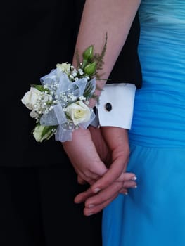 White rose wrist corsage with white ribbon and babies breath.