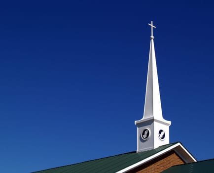 Church steeple with praying hands and space for copy.