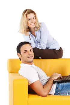 Happy young man and woman sitting together and looking at computer screen