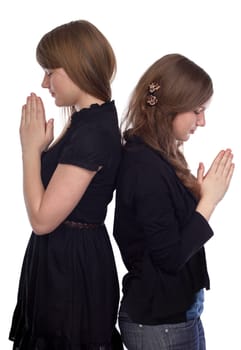 Two girls standing back to back at the time of prayer