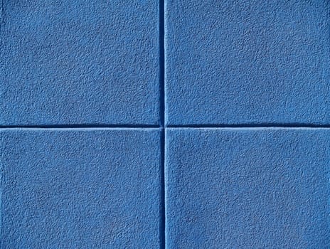 Four blue squares on a concrete wall, powerpoint background and copy space.