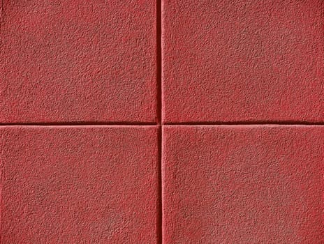 Four red squares on a concrete wall, background and copy space.