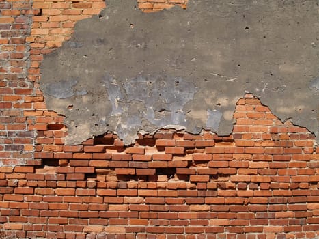 Old weathered wall with red multi-sized brick and a patched area.