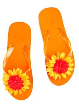 orange flip-flops with flowers on a white background