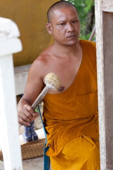 Buddhist monk doing spiritual drumming in the temple