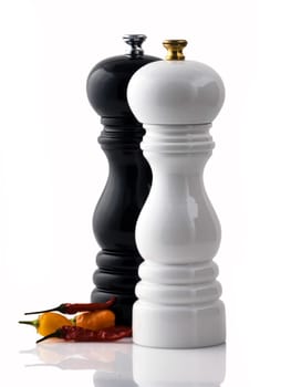 Large polished wooden, pepper/salt mill with chilli on white background
