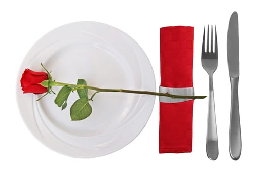 Place setting on whtie plate and red rose on white Background