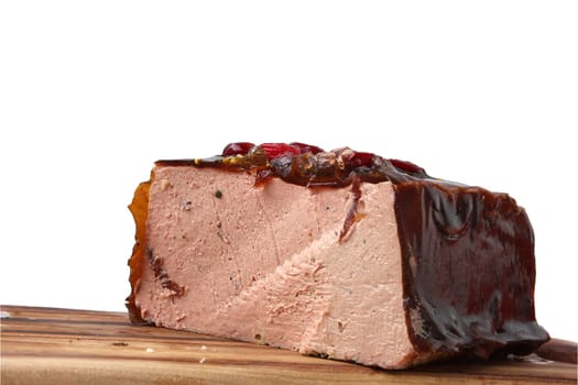 Pâté de foie gras with black truffles and cranberries on a kitchen board