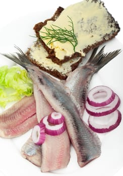 Portion of matjes with brown bread and onions