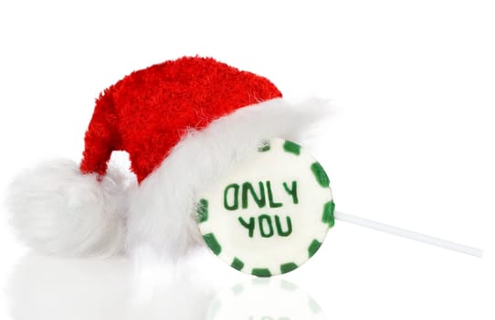Christmas lovely Lollipop with Santa Hat isolated on white.