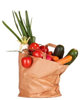 Grocery bag with vegetables isolated on white