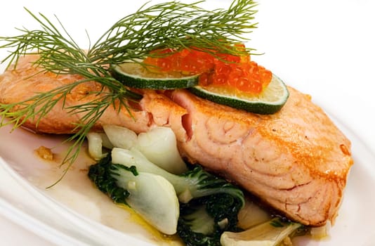 Broiled salmon steak with spinach and red caviar