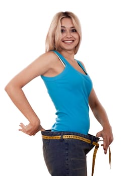 Young happy woman measuring her waist over white background