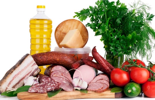Arrangement variety of processed cold meat products with vegetable on white background