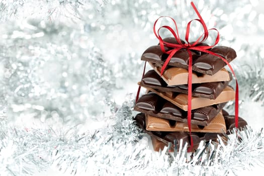 Christmas chocolate stack present on a fluffy background Wintery Decoration