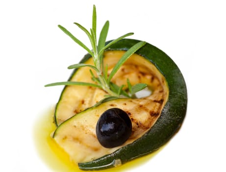 Grilled zucchini rolled up with olive in olive oil