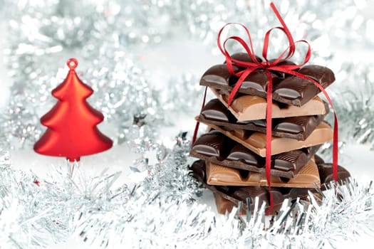 Christmas chocolate stack present on a fluffy background Wintery Decoration