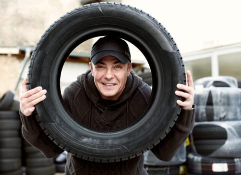 handsome Men with friendly face and Car Tire at an auto shop
