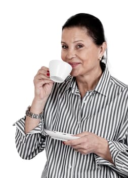 woman looks at newspaper and drinks her coffee against white background