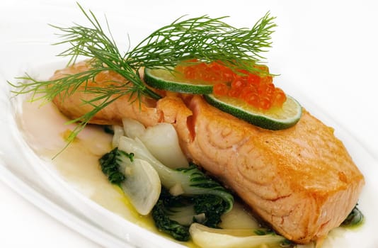Broiled salmon steak with spinach and red caviar
