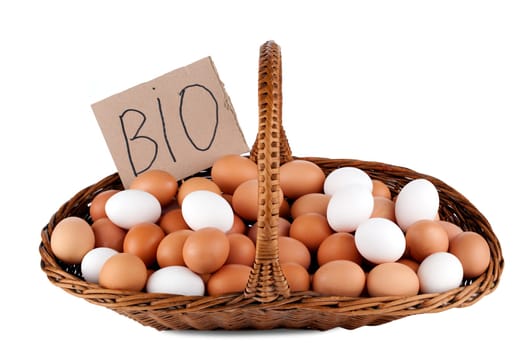 Hens eggs in a basket isolated on white