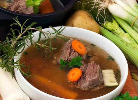 bowl of Beef Soupl with carrot, leeks, celery and spices, ready to serve.
