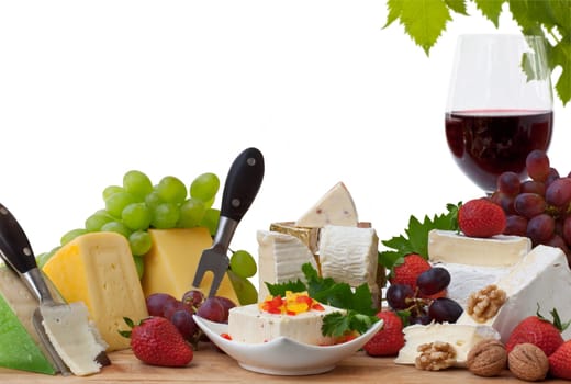 Glass of red wine and assorted cheeses with Fruit