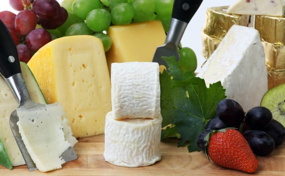 Glass of red wine and assorted cheeses with Fruit