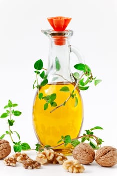Walnut oil with nuts on a white background