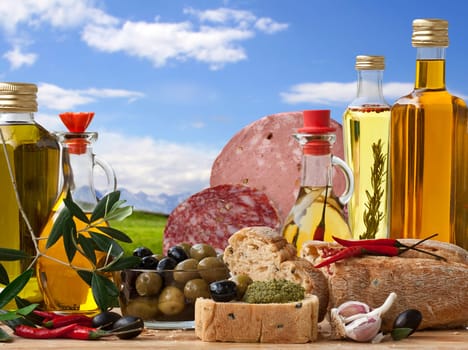 Decorative Italian deli with 5 different Olive Oil, Italian Bread, Italian Baloney and Salami, Olive and ingredient on a Landscape Background.
