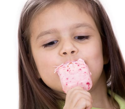 A little girl eats an ice cream. Isolated on white