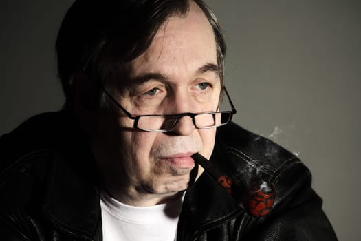 Senior man smoking a tobacco pipe