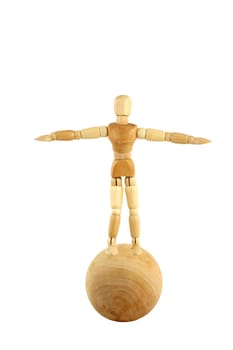 A Wooden manikin standing on ball