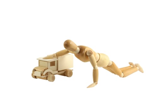 A Wooden manikin playing with truck